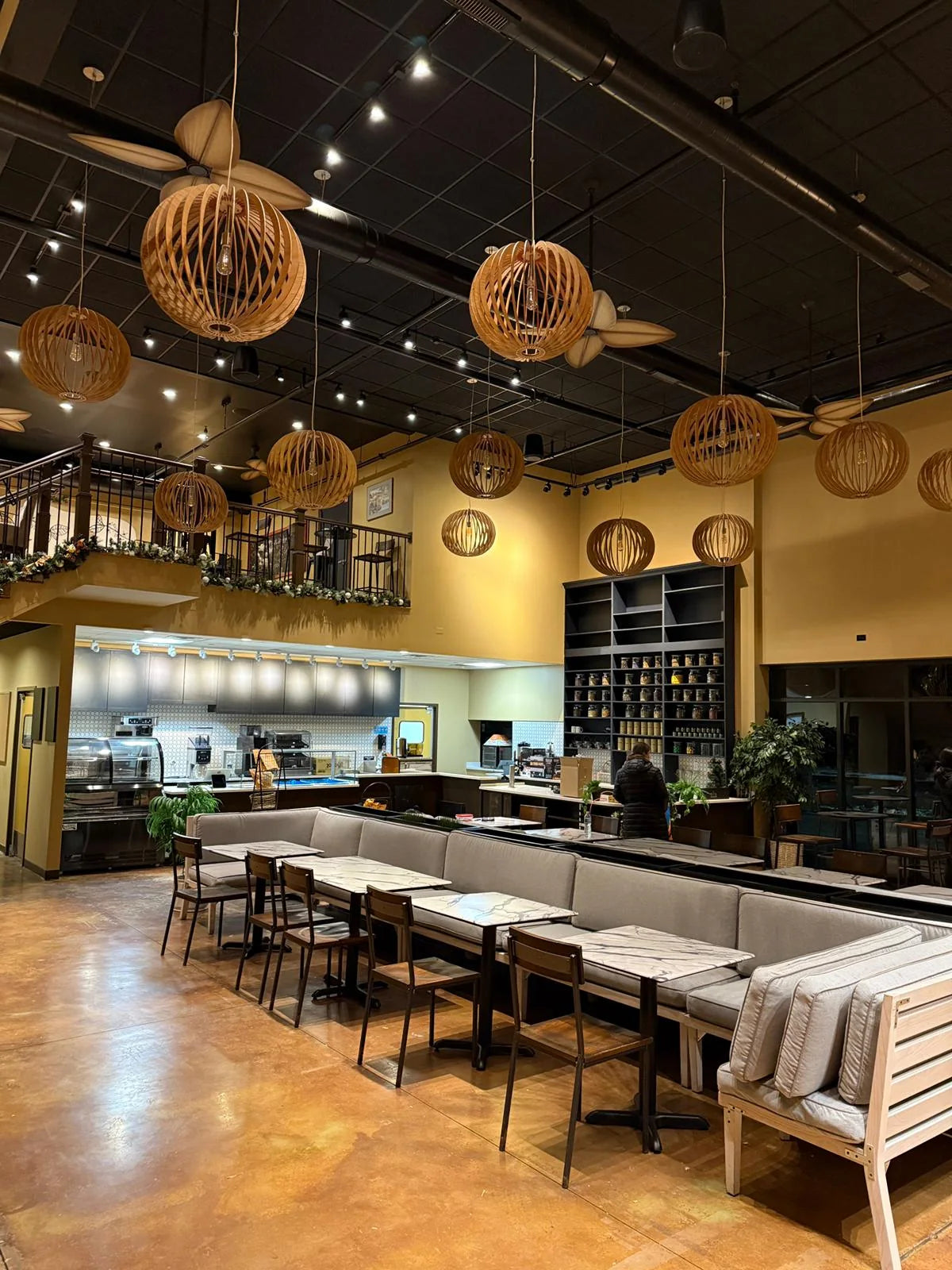 The actual Activitea Wheaton café interior, with warm pendant lighting and seating