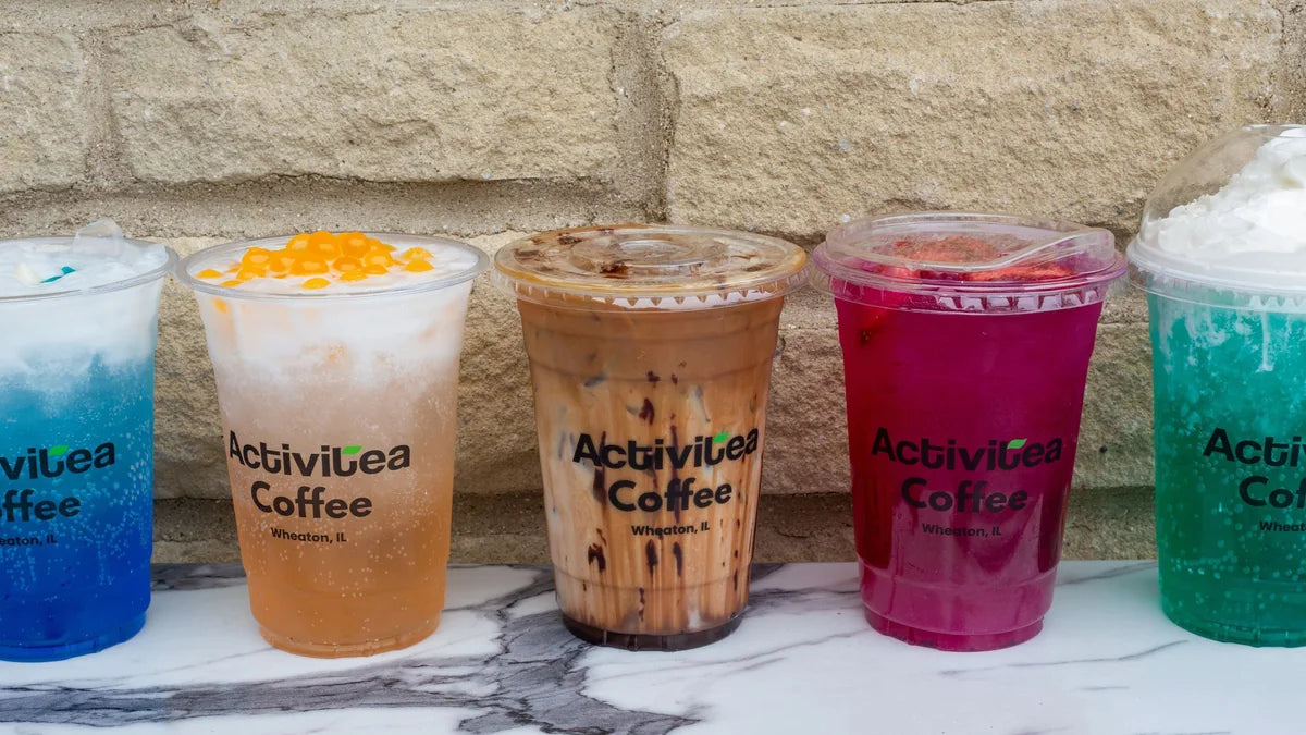A colorful lineup of Activitea Coffee drinks in branded cups